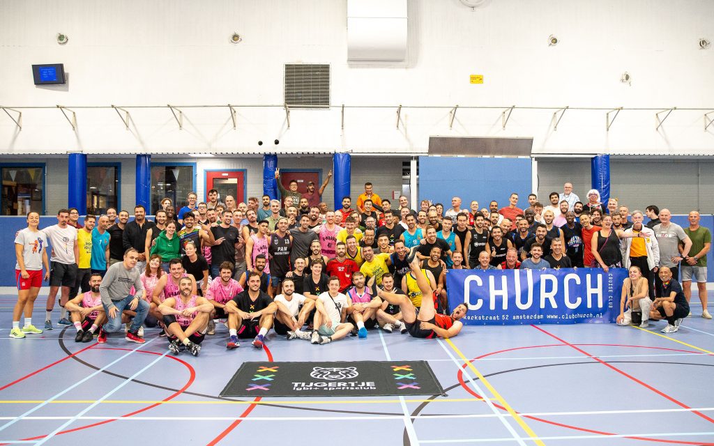 Group photo of basketball tournament participants on the court